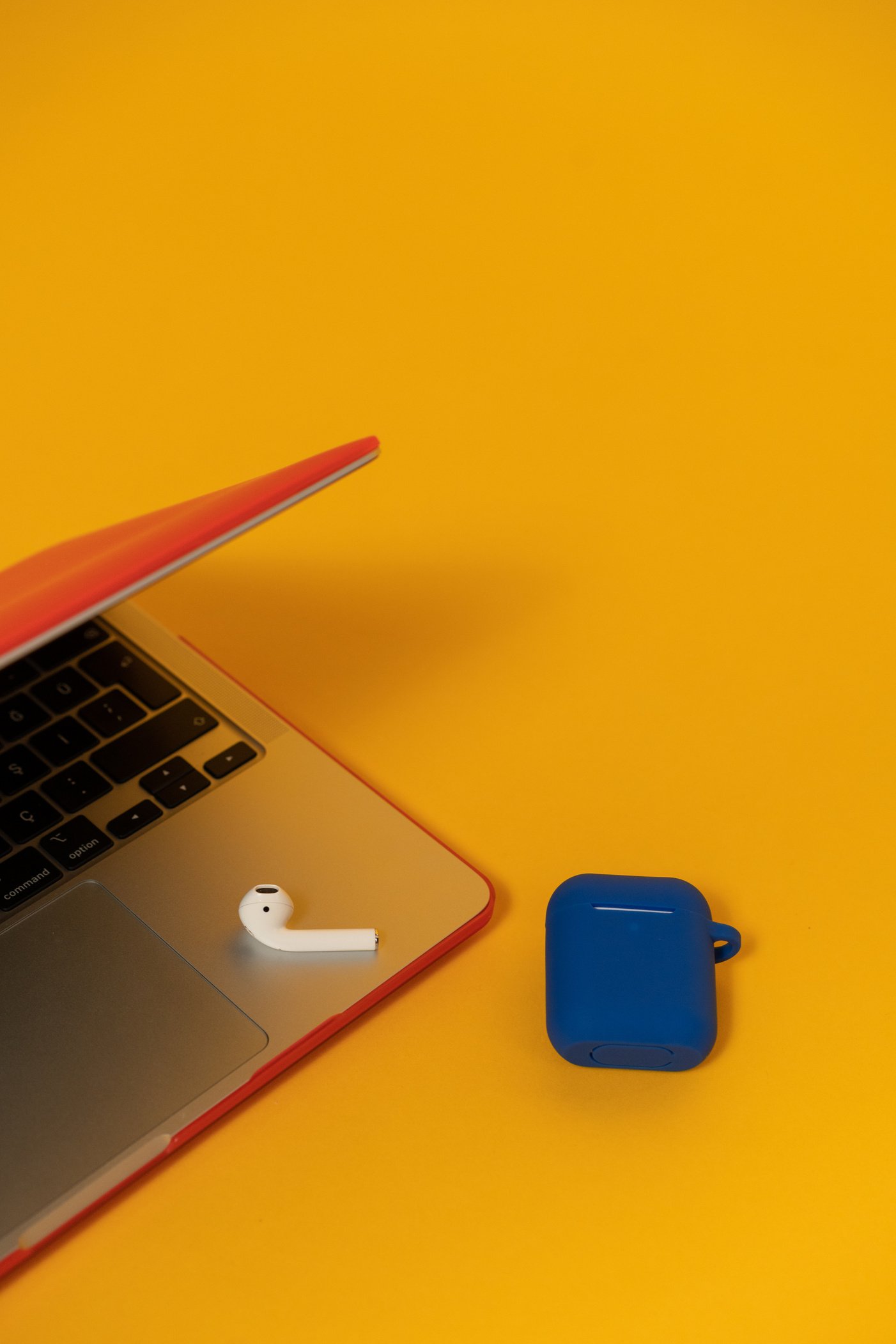 Tech Humans Laptop and Earbuds on Yellow Background